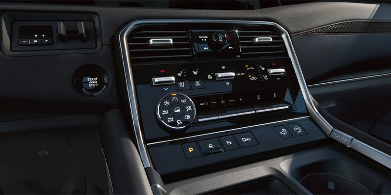 The center console full of safety features in the 2025 Nissan Armada in Pompano Beach, FL